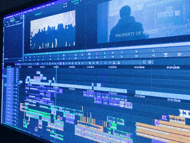 A video editing timeline on a large monitor